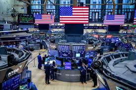 Nasdaq futures chart on trading desk monitors showing live levels for October 18, 2026