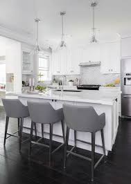 The right bar stools can blend seamlessly with your bar, matching its style and sitting at just the right height for the counter. White Island With Gray Leather Bar Stools Transitional Kitchen