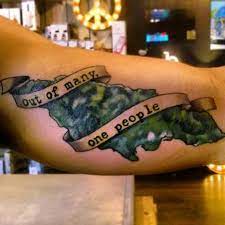 See more ideas about tattoos, jamaican tattoos, body art tattoos. Jamaican Tattoo With The Island S Motto Out Of Many One People Jamaican Tattoos Tribal Back Tattoos Tattoos