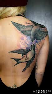 There are two different bird tattoos on the body. Shoulder Back Bird Tattoo By Kipod Studio