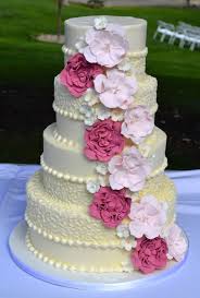 The base is coated with white icing with the ripple effect design. Floral Wedding Cakes Amaru Confections