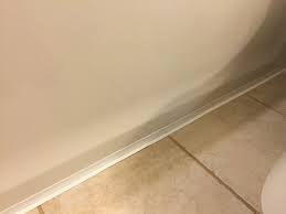 Read this cautionary tale before you start your bathroom diy! Installing Caulk Strip Over Cracked Grout