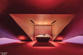Modern loft interior of living room, coral armchairs with white cabinet on wood flooring and white wall ,3d rendering. 14 Red And Pink Interiors Tell Their Own Love Stories Interior Design Magazine