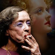 72-year-old Bette Davis in 1980, in front of an image of herself from 1939.  (Reposted via @ClassicMovieDig)