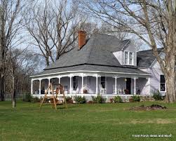 A nicely detailed covered porch wraps around three sides of this farmhouse design extending the living area to the outdoors. Farm House Porches Country Porches Wrap Around Porches