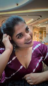 The necklace, a cascade of twinkling stars, caresses her neckline, echoing  the radiance of her spirit. Earrings, like shimmering raindrops, sway  gently by her temples, carrying secrets whispered by ...