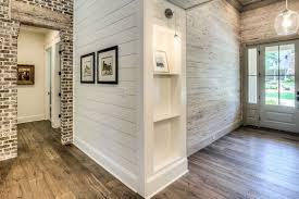 Shiplap materials can cost from $900 to $2,600, while professional labor would add an extra $3,000 to $5,000, totaling about $2,800 to $7,500 for a 2,700 square foot home. Vintage French Soul Love The Brick Wall With Wood Beam Above Door Opening Shiplap Walls Home House Cheap Home Decor