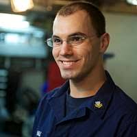 Information Systems Technician Seaman Dwight Ogle inspects the black audio  switch in the combat systems message center