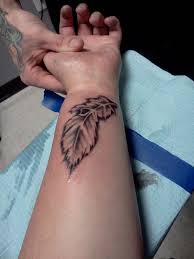 Anchor and feather tattoos on wrist. Adorable Feather Tattoos Ideas