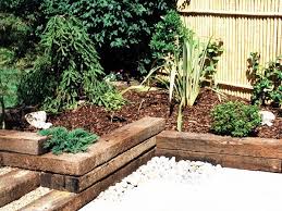A medium sized garden of 'lawn and beds' was transformed into a colourful gravel garden to compliment a sussex barn conversion. 28 Gardens With Railway Sleepers Ideas Garden Design Railway Sleepers Sleepers In Garden