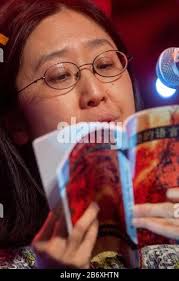 12 March 2020, Saxony-Anhalt, Magdeburg: Chong Jiong Wang reads from the  German-Chinese poetry volume ".dancing languages." published by the  German-Chinese Society Saxony-Anhalt at the event "Magdeburg reads anyway!  After the cancellation of