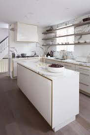 These designs also ensure that the floating kitchen cabinets can blend in all types of kitchens, whether it is traditional, contemporary, rustic or transitional. White And Gold Kitchen Cabinets With Gray Floating Shelves In Front Of Windows Contemporary Kitchen