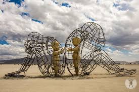 As the sun sets and the moon rises, the two young figures light up and set the surrounding area aglow. Inner Child Inner Child Burning Man Art Inner Child Healing