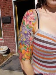 Floral half sleeve tattoo for women. Colored Flowers Half Sleeve Tattoo For Girls
