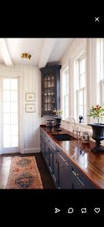 I Love The Corner Cabinet Dark Cabinets With Wood Counter Tops And White Walls Kitchen Remodel Kitchen Inspirations Kitchen Design