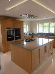 You might even be motivated to remodel or redecorate your own kitchen. Suspended Ceiling With Lights And Flat Extractor Hood Over Kitchen Island Kitchen Ceiling Design Kitchen Design Small Kitchen Design