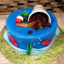 Easy decorations, such as a powdered sugar doughnut dinghy. Fishing Birthday Cake Fishing Birthday Party Boys Fish Cake Birthday Fishing Birthday Party