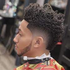 The longer kinky hair on top is a fashionable mohawk cut for black hair. Black Mohawk Fade Haircut For Guys Black Mohawk Hairstyles Mohawk Hairstyles Men African Hairstyles