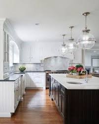 White Kitchen With Espresso Island The Island Countertop Is A Calacatta Marble The Peri Gorgeous White Kitchen Black Kitchen Countertops White Kitchen Design