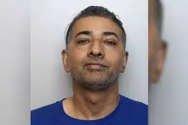 Dad battered mum holding their baby in her arms