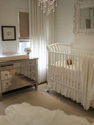 A white double door opens to this aqua nursery showcasing a charming floral rug and dark wood crib with a framed baby's name on top. Boho Baby Nursery Rug Novocom Top