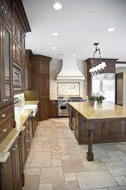 This kitchen features a tile backsplash sandwiched between white countertops and light wood cabinets, as well as a large dark island at the center. 101 Traditional Kitchen Ideas Photos Traditional Kitchen Design Modern Kitchen Tiles Kitchen Design