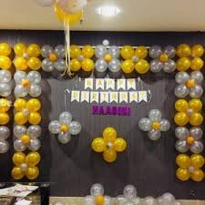 Around 30 balloons with ribbons are placed on the ceiling and rest are placed in the form of balloon bunches or free floating on floor. Metallic Yellow Sliver Home Birthday Decoration Anil Events Bangalore