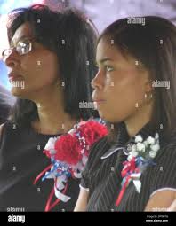 Dr. Barbara Porchia, left, mother of Army Spc. Jonathan Cheatham, and his  sister Portia Cheatham, sit at the graveside funeral service for Cheatham  Sunday, Aug. 3, 2003, at Memorial Park Cemetery in
