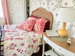 The wicker headboard, especially like this one, is a fantastic option to romantic and classic interiors. Flower Bedroom Flower Toile Wallpaper Wicker Headboard Desk Nightstand Yellow Light Pottery Barn Bed Wallpaper Bedroom Flower Bedroom Pottery Barn Bedding