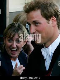 Britain's Prince William, left, reacts alongside Geoff Pollard, the  president of Tennis Australia as they watch the match between Roger Federer  of Switzerland and Romania's Victor Hanescu