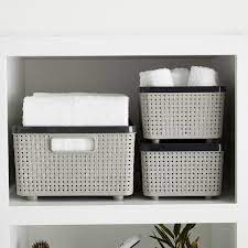plastic and decorative baskets are great for storing towels and washcloths in your bathroom linen closet storage bins fabric storage bins plastic storage bins