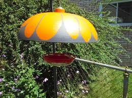 Diy Decorated Squirrel Baffle To Shade Humminbird Feeder Not Only Keeps Sugar Water Much Cooler But Squirrel Baffle Diy Squirrel Baffle Humming Bird Feeders