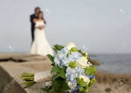 When the guests arrive for a wedding, the ushers, if any, help the guests take their places. Wedding Bouquet With Bride And Groom In Background Stock Photo Picture And Royalty Free Image Image 3146896
