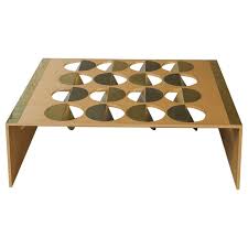 Most coffee tables are made of wood (though faux wood tables are increasingly common) or glass and metal, typically, stainless steel or aluminum and may incorporate cabinets or drawers. Geometric Coffee Table Oak Wood Brass Metal Stainless Steel By Ana Volante Stock For Sale At 1stdibs