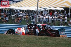 The remnants of the Bill Elliott/Dan Marino Ford Taurus heads to pit road  after an incident at Watkins Glen during the 1998 Bud at the Glen. Driven  by Tom Hubert