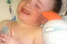 Brave John McElduff (7) defies horror injuries to ride bike for first time 