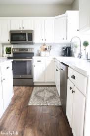 How Our Laminate Flooring Are Holding Up Virtually 2 Years Later Laminateflooring White Kitchen Decor House Flooring Kitchen Cabinets Decor
