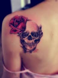 While you might look at the black rose tattoo and thing it only represents the darker side of life, this isn't necessarily true. Skull Tattoo Decoated With Red And Black Roses
