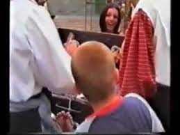 I found it on the web, it is a picture of a medieval french renfaire, pultroppo i did not find the video. Renfaire Tickling 2002 Youtube