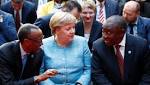 Merkel urges companies switch focus
