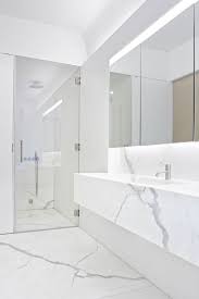 The floor with an inset basket weave of carrara marble and black granite dots is one of the final touches that infuses old world opulence into this master bathroom. 34 Stunning Marble Bathrooms With Silver Fixtures Marble Bathroom Designs White Marble Bathrooms White Bathroom Designs
