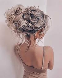 The waves in this style create a messy look that is a bit flirtatious as it flows over the shoulder. 25 Long Blonde Updo Hairstyles Blonde Hairstyles 2020