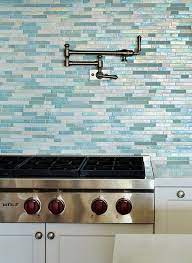 Interior designer danielle colding used a glass backsplash for a shinier, more modern and cosmopolitan touch the mirrored tile backsplash contrasts nicely with the casual wicker stools. 30 Awesome Kitchen Backsplash Ideas For Your Home Glass Tile Backsplash Kitchen Glass Tiles Kitchen Kitchen Backsplash Tile Designs