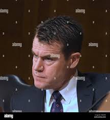 U.S. Indiana Senator Todd Young (left and U.S. Vice President Mike Pence  (right) swear in U.S. Surgeon General Dr. Jerome Adams at the White House  Septemer 5, 2017 in Washington, DC.(photo by