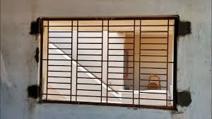 The arched curve on the upper section of white grille set within the window frame gives a romantic touch to this window with artistic grill shaped like plant with leaves is the result of a creative mind that wanted to. Window Grill Installation House Construction Youtube