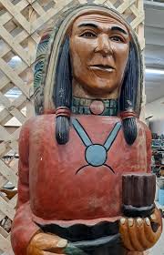 Beautiful Indian holding peace pipe. He is 6' 10 1/2" tall. Fine coloring  and his facial expression is intriguing. Can be seen at Rags To Riches  Antiques College St Harrodsburg. 859.734.2680. (s4061).