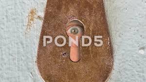 Male Eye Peeking Through Vintage Keyhole In An Old Wooden Door Stock Footage Peeking Vintage Male Eye Old Wooden Doors Male Eyes Wooden Doors