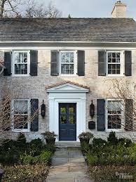 It is a design of a whitewashed brick house with black window shutters. Front Door And Shutter Colors Door Inspiration For Your Home