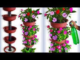The flowers are all made from recycled glass. Beautiful Flower Garden Tower Using Terracotta Pots For Your Small Home Garden Green Plants Y Beautiful Flowers Garden Flower Pots Outdoor Flower Pot Garden