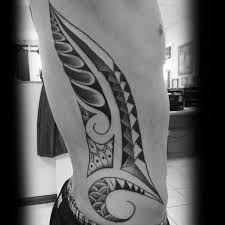 From just under the chest all the way down to the hip; Top 40 Best Tribal Rib Tattoos For Men Manly Ink Design Ideas
